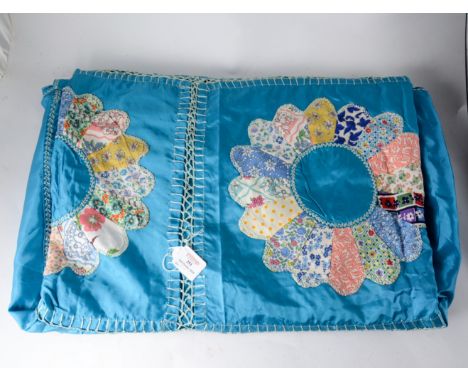 A vintage red and white patchwork quilt of a geometric design, a blue rayon quilt with floral cotton patchwork daisy panels. 