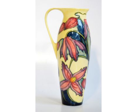 MOORCROFT; a modern floral pattern tube line decorated pitcher on yellow ground impressed marks and signatures to the base by