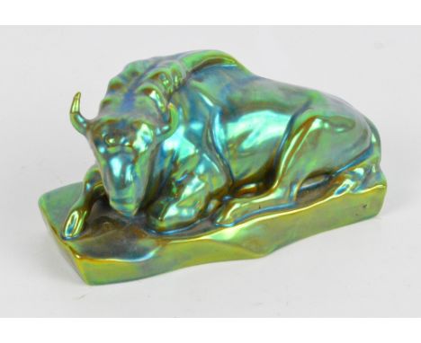A Zsolnay Pecs ceramic green lustre glazed figure of a recumbent bull on shaped rectangular base, marked to underneath, lengt
