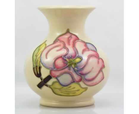 MOORCROFT; a modern "Magnolia" pattern tube line decorated baluster vase on cream ground, impressed marks to base, candlestic