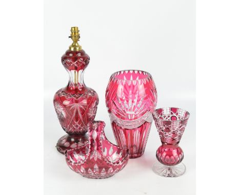 A ruby flash cut glass lamp base of baluster form, height 38.5cm excluding fitting, a tall tapering vase, height 30.5cm, a ba