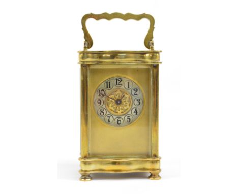 A late 19th/early 20th century French brass cased carriage clock with serpentine sides to top and base, the circular chapteri