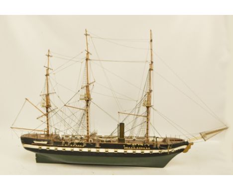 A scratch built model of a three masted ship, painted in green, black and white, length 90cm.