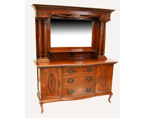 An Edwardian mahogany mirrored back sideboard, the mirror above a central shelf flanked by double pillars over three long cen