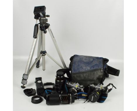 Two vintage Olympus cameras, models OM20 and OM10, a group of lenses to include 58mm and 70-210mm, etc, also a Slik 35 DN tri