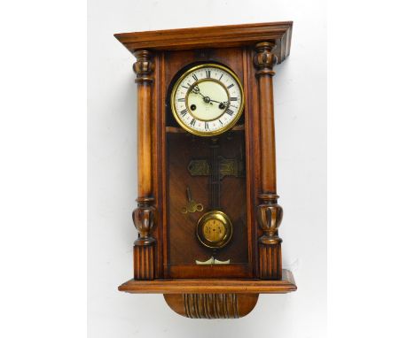 A late Victorian walnut and beech spring driven eight day wall clock, the circular two-piece enamel dial set with Roman numer