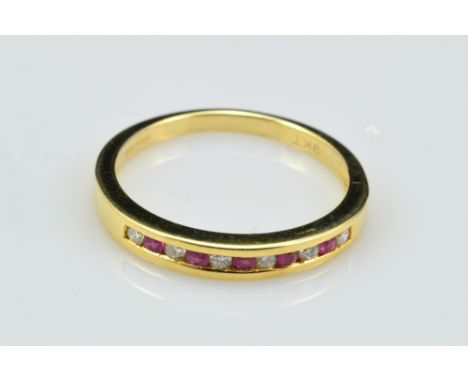 A 9ct yellow gold ruby and diamond half eternity ring with eleven alternating stones in bezel setting, size O, approx 2.3g.