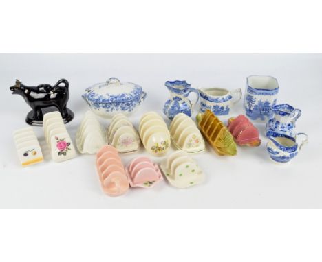 A collection of ceramic toast racks including examples by Royal Winton, Shorter, Johnson Brothers, etc plus a cow creamer and