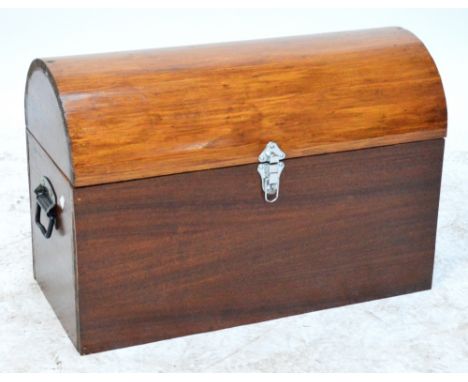A pine and mahogany trunk with dome hinged lid and twin handles, 68.5 x 32cm, height 47cm.