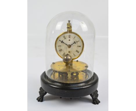A late 19th/early 20th century brass perpetual motion clock with rotary spherical pendulum, the circular enamel dial set with