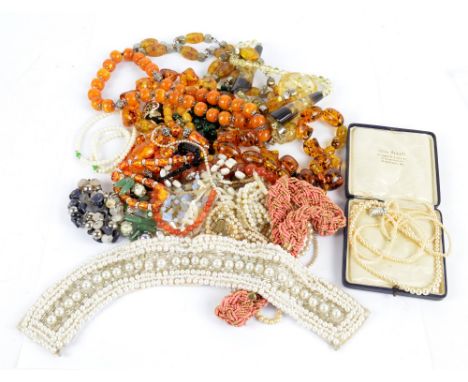 A large quantity of costume jewellery including simulated amber beaded necklace, simulated pearl necklaces, beaded bracelets,
