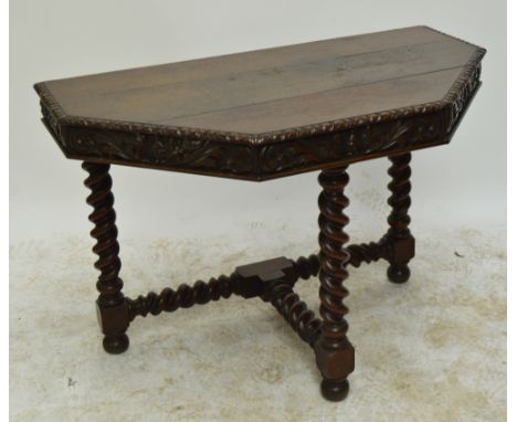 A 20th century carved oak console table with phoenix frieze decoration, on barleytwist legs to bun feet.