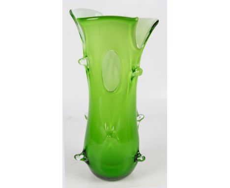 A large 1970s vintage green glass vase with white glass interior, in the shape of an abstract tree stump with piercing, heigh