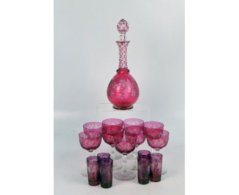 An early 20th century ruby tinted glass decanter with etched grape and vine decoration to globular body, with slender neck, h