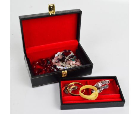 A group of costume jewellery to include a wrought gold foliate scroll engraved snap bangle, a hallmarked bracelet and various