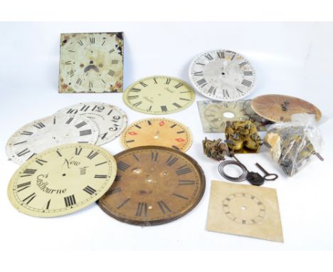 A group of various enamel predominantly circular longcase/wall clock dials, also three clock movements.