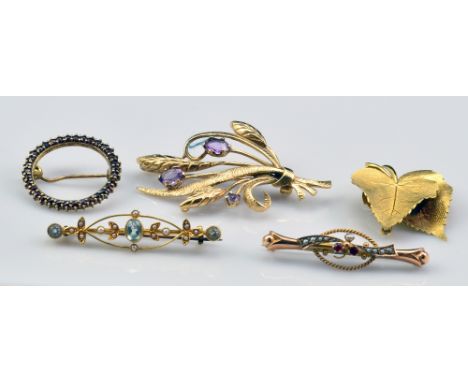 A group of brooches comprising a 15ct yellow gold Edwardian floral seat cultured pearl and blue stone set example, a similar 