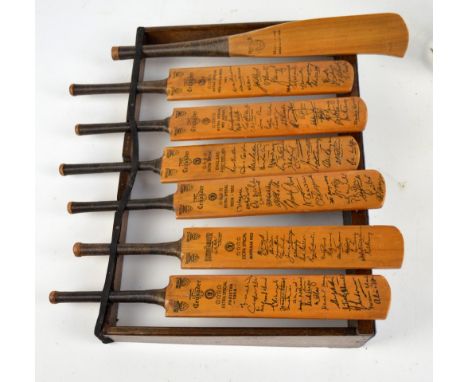 A small collection of late 1940s/early 1950s miniature commemorative cricket bats bearing facsimile signatures for West Indie