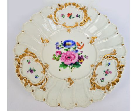 An early 20th century Meissen gilt heightened plate centred with a hand painted vignette of floral sprays with blue crossed s
