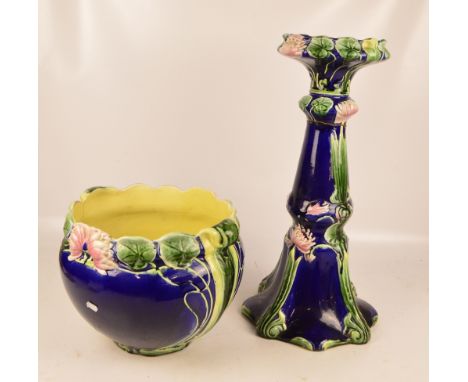 A majolica glazed jardinière and stand on a blue ground with water lily and foliate decoration (af), length 6cm.   CONDITION 