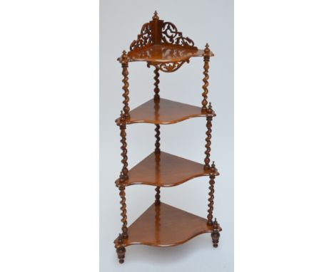 A Victorian walnut four tier serpentine corner whatnot with fret work to the top and with barleytwist supports, height 124cm,