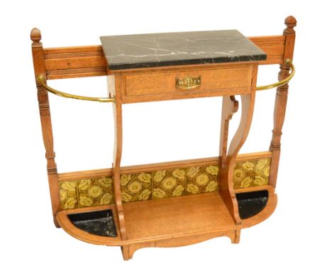 ATTRIBUTED TO SHOOLBRED; an early 20th century stick stand with black marble top above single drawer flanked by two brass fra