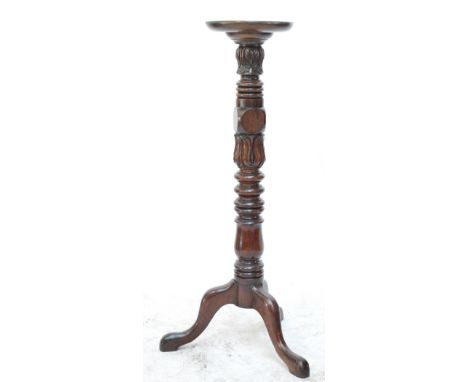 A 19th century mahogany jardinière stand, the circular top on carved turned column and tripod supports, diameter of top 29cm.