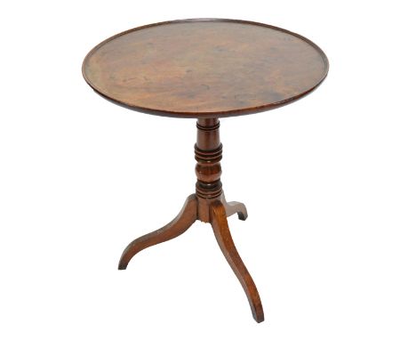 A George III mahogany tripod occasional table, the one-piece dish top above ring turned central column to three outswept supp