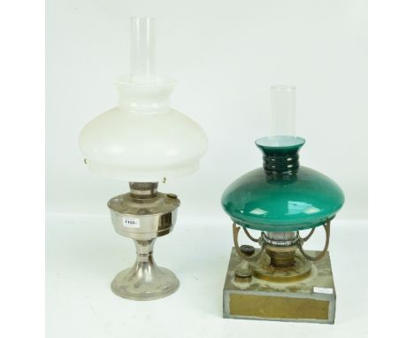 A brass oil lamp of square form, with associated glass white shade and a further chrome example with a green glass shade.
