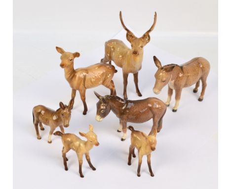 Seven Beswick figures: a donkey trio, model nos. 2267a, 2110 and 1364b, and stag trio, model nos. 981, 999a and 1000a, and an