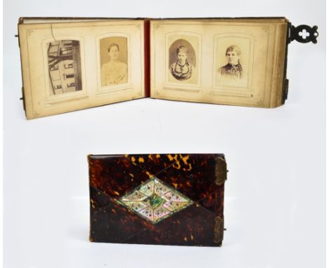 A late Victorian photograph album with tortoiseshell boards, brass clasp and front set with an inlaid mother of pearl and aba