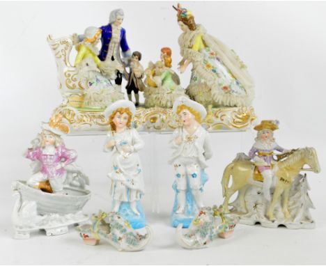 A collection of decorative ceramic figures including a pair of figural spill holders, a figure group on a gilt heightened pli