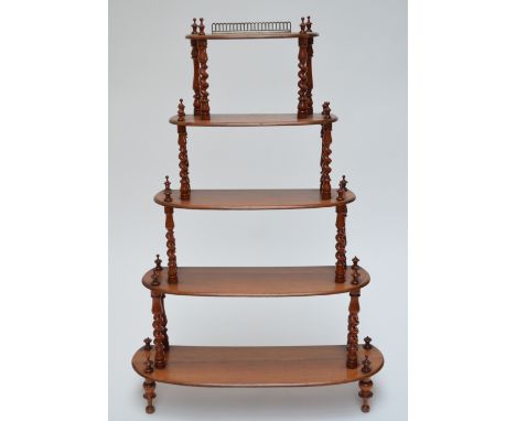 A Victorian walnut five tier oval whatnot, with barleytwist and ring turned supports, height 110cm, the bottom shelf width 74