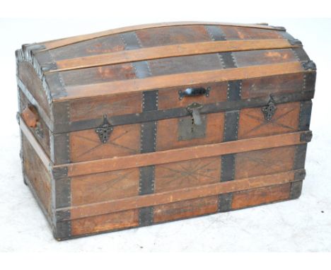 A domed leather covered metal and wood bound trunk with twin handles, 91 x 47.5 x 58cm.