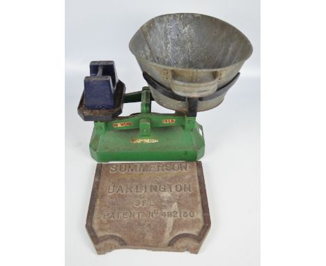 A set of vintage cast iron scales with four stacking weights and a seven lb weight Avery example, also an iron "Summerson Dar