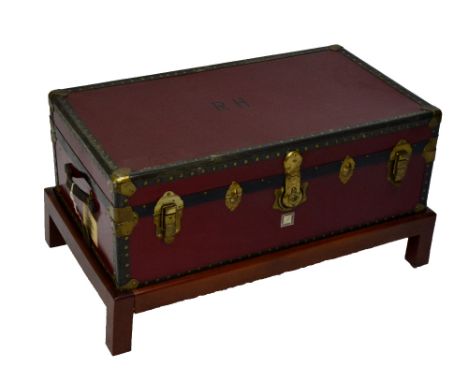 A decorative 20th century rectangular lidded trunk set on a low wooden stand, width 92cm.