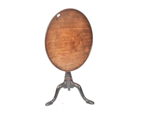 A George III 19th century mahogany tilt top loo table. The table having a pie crust lipped circular top over a tilting & twis