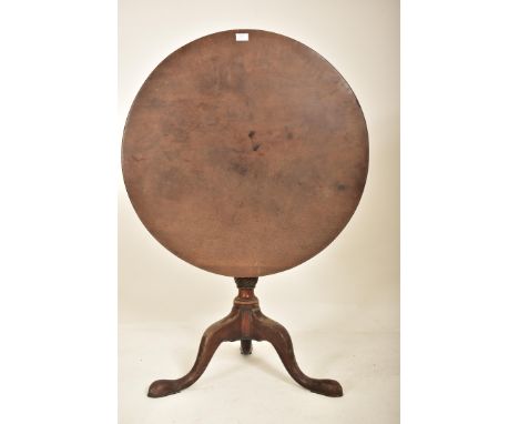 A George III 18th century mahogany tilt top tripod table. The table having a circular hinged tilt top over a turned central c