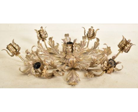 An Italian inspired toleware style gilt metal six arm ceiling light. The chandelier having six arms with scrolled leaves bulb