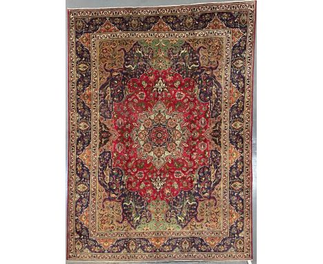 An early 20th century North West Persian Islamic Tabriz floor carpet rug. The carpet having a series of graduating central me