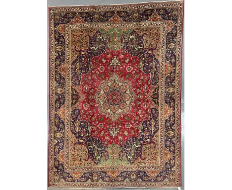 An early 20th century North West Persian Islamic Tabriz floor carpet rug. The carpet having a series of graduating central me