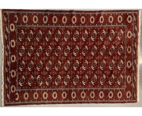 An early 20th century circa 1920s Turkmen Islamic virgin wool floor carpet rug. The rug in burgundy colourway with central pa