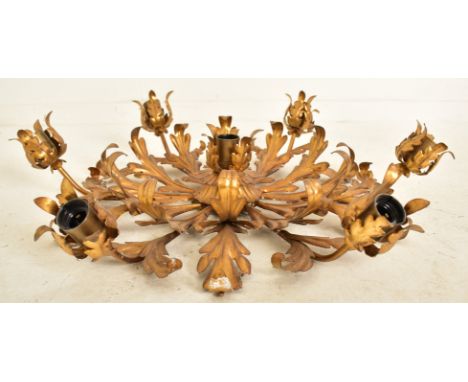 An Italian inspired toleware style gilt metal six arm ceiling light. The chandelier having six arms with scrolled leaves bulb