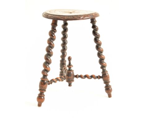 A French continental 19th century carved oak milking stool. The stool having a carved round seat with floral decoration. Rais