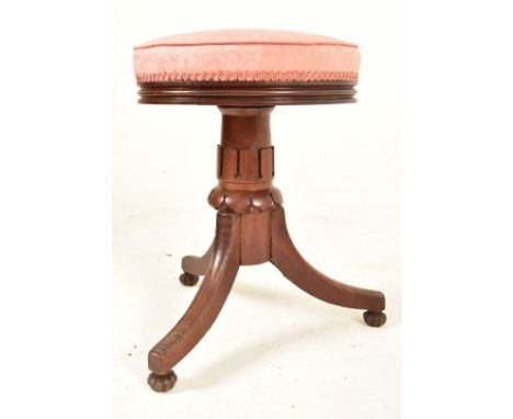 A William IV 19th century carved rosewood piano revolving stool seat. The stool having a circular upholstered padded seat ove