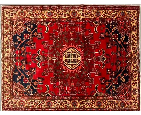 A 20th century North West Persian Islamic Tafresh floor carpet rug. The rug having a central red, black &amp; burgundy centra