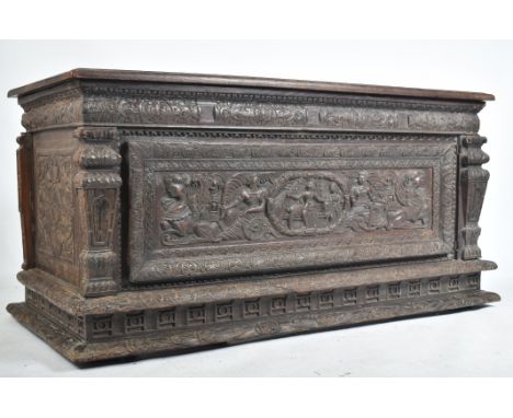 A 16th century carved Italian large Cassone converted to a desk. The heavily carved front panel in relief with scenes of scro