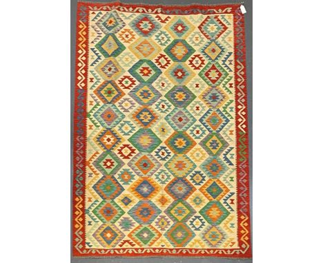 A 20th century Anatolian Turkish Islamic Kilim floor carpet rug. The rug having a central cream panel with polychrome repeati