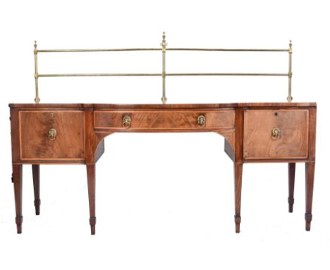 A late 18th century George III Sheraton manner sideboard credenza. Raised on square tapering legs with bow breakfront centre 