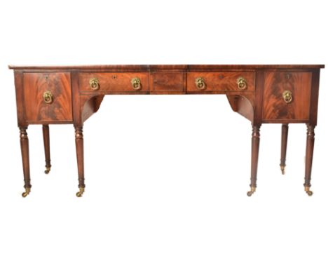 A late 18th century George III mahogany credenza &ndash;&nbsp;sideboard. The credenza being raised on turned and tapering leg